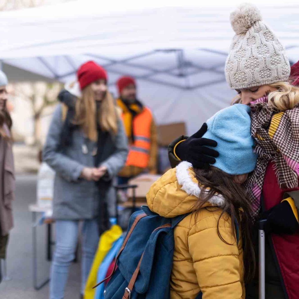 The Ukrainian refugee mother with child crossing border.